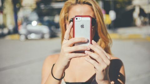 Girl holding up smartphone