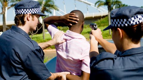 Police pointing gun at motorist