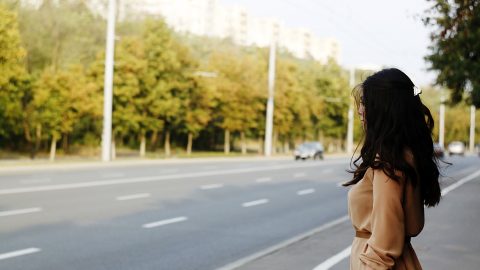 Female waiting by a road