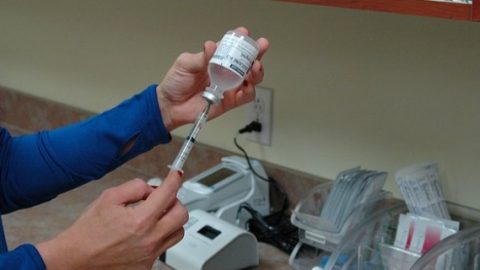 Nurse preparing a syringe