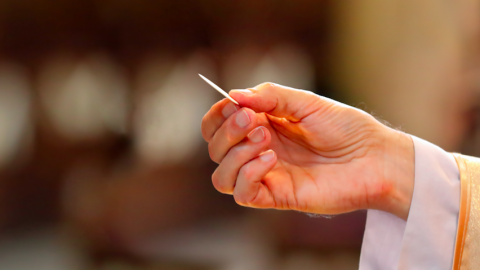 Catholic priest holding communion