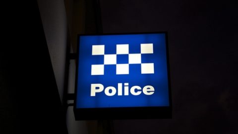 Police sign at night