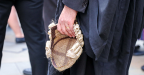 Barrister holding wig