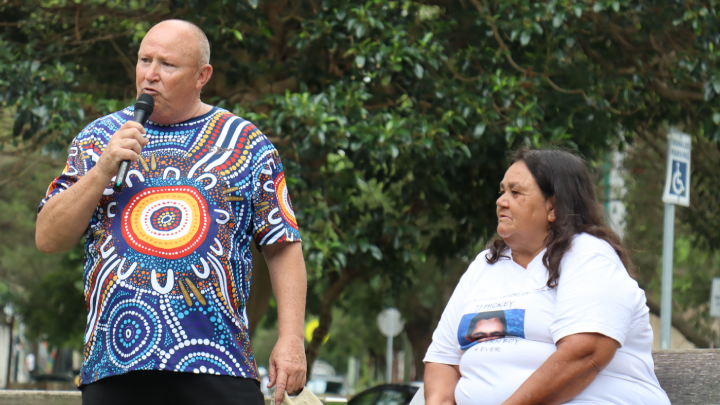 Uncle Dave Bell addresses the crowd, with Aunty Gail Hickey to his side